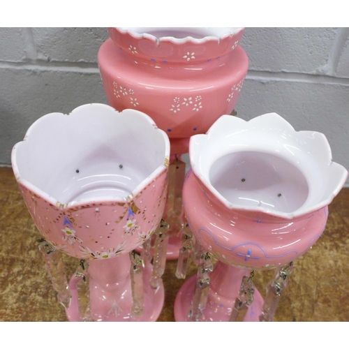 820 - Two similar pink glass lustres and one larger lustre (one drop a/f)