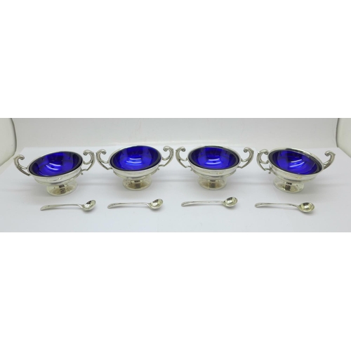 850 - A set of four silver salts with blue glass liners, Birmingham 1907, the spoons hallmarked London 190... 