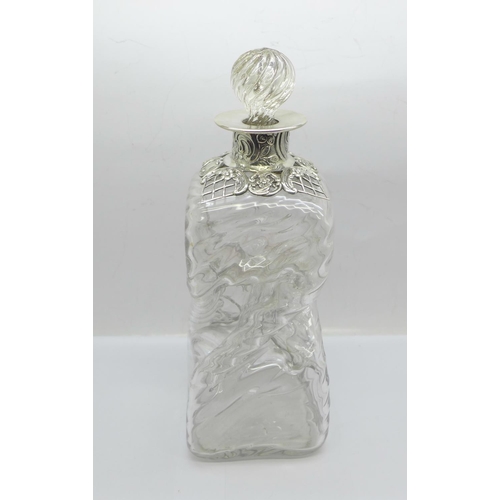 855 - A late Victorian silver topped glass decanter, London 1892, William Comyns, inner rim of glass a/f