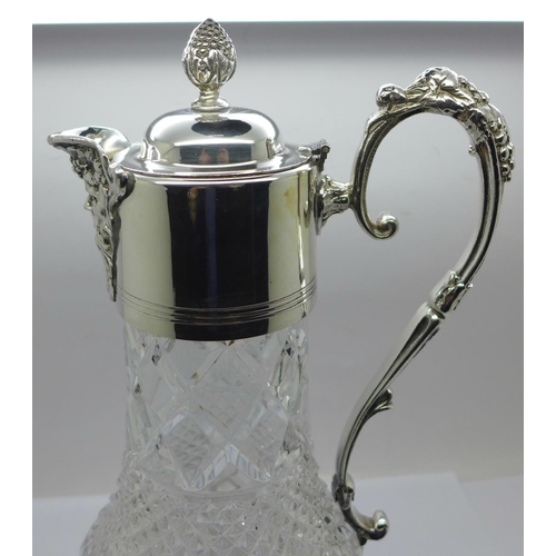 860 - A white metal mounted glass claret jug, marked 999 on the handle and lid