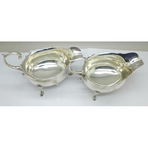 862 - Two similar silver sauce boats, both marked Harrods, London S.W., and both hallmarked London 1914, 2... 