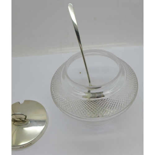 863 - A silver topped glass preserve pot, Birmingham 1902, and a silver spoon, Sheffield 1933 by Walker & ... 