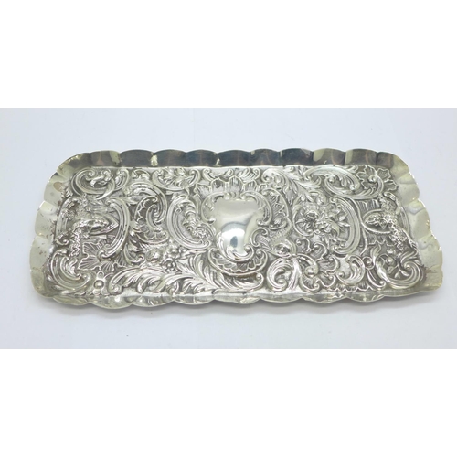 874 - An embossed silver tray, London 1900, William Comyns, 127g, 10.5cm x 24cm