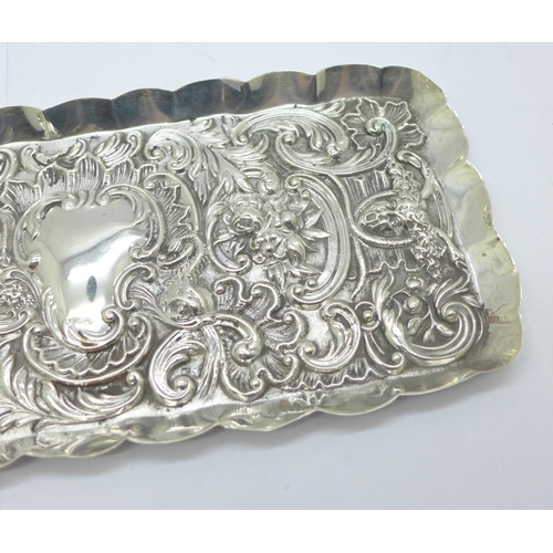 874 - An embossed silver tray, London 1900, William Comyns, 127g, 10.5cm x 24cm