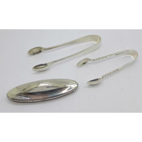 878 - Two pairs of silver sugar tongs, 42g, and a silver mounted nail buffer