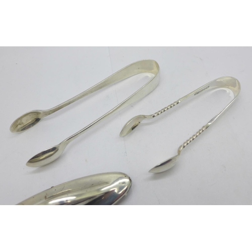 878 - Two pairs of silver sugar tongs, 42g, and a silver mounted nail buffer