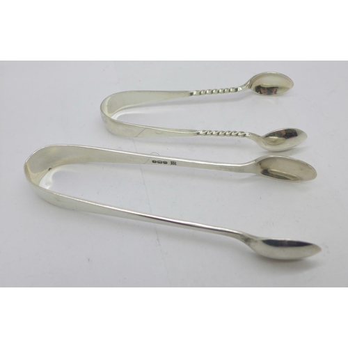 878 - Two pairs of silver sugar tongs, 42g, and a silver mounted nail buffer