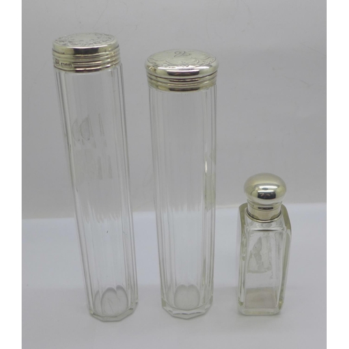 882 - A silver topped glass scent bottle and two silver topped glass bottles, glass chipped on rim of one ... 