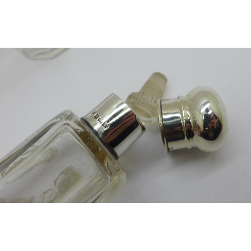 882 - A silver topped glass scent bottle and two silver topped glass bottles, glass chipped on rim of one ... 