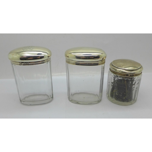 887 - Three silver topped glass jars including one Victorian, 64g of silver, tops dented