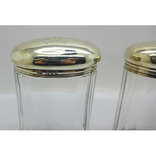 887 - Three silver topped glass jars including one Victorian, 64g of silver, tops dented