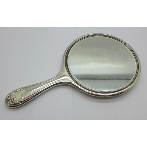 889 - A silver backed hand mirror, silver dented