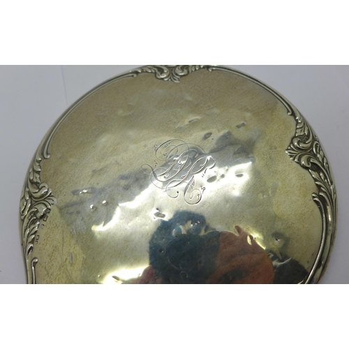 889 - A silver backed hand mirror, silver dented