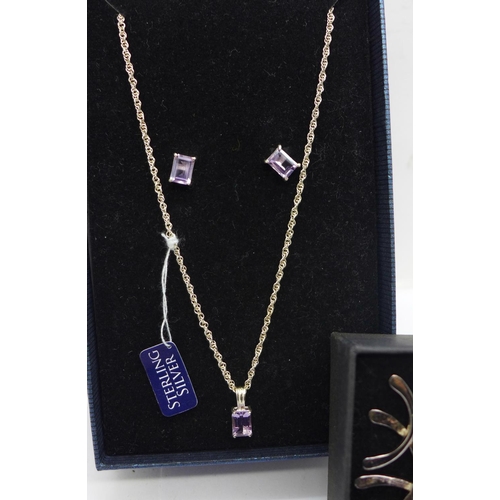 914 - A silver pendant with matching earrings and two pairs of silver earrings