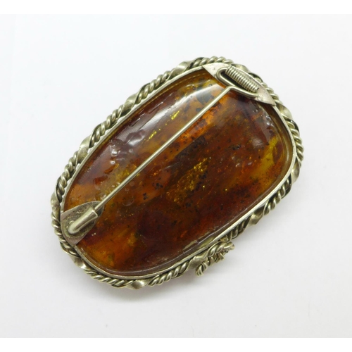 974 - An amber brooch, (mount tests as silver)