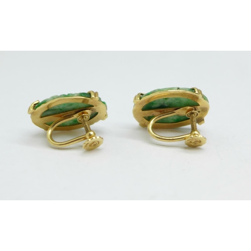 994 - A pair of 14ct gold and carved jade earrings with screw backs, 14mm x 20mm