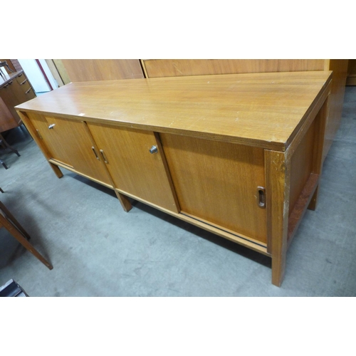 116 - A teak sliding two door sideboard