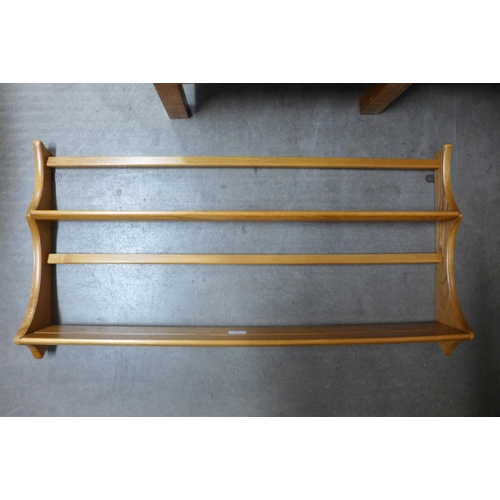 117 - An Ercol Blonde ash wall rack