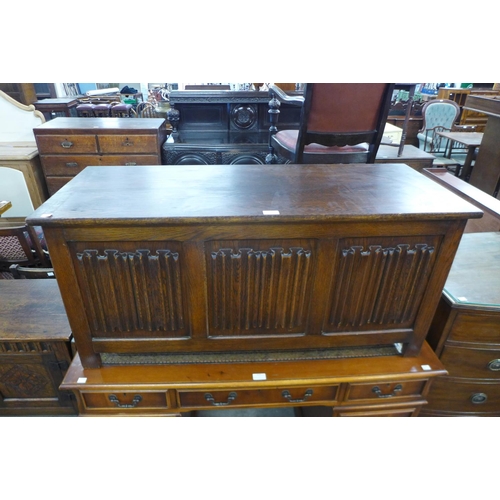 125 - A carved oak linenfold blanket box