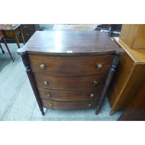 129 - A Regency style mahogany bow front chest of drawers, made by Paine Furniture Co., Boston, Mass.