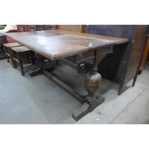 156 - An oak extending refectory table and four ladderback chairs