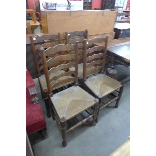 156 - An oak extending refectory table and four ladderback chairs