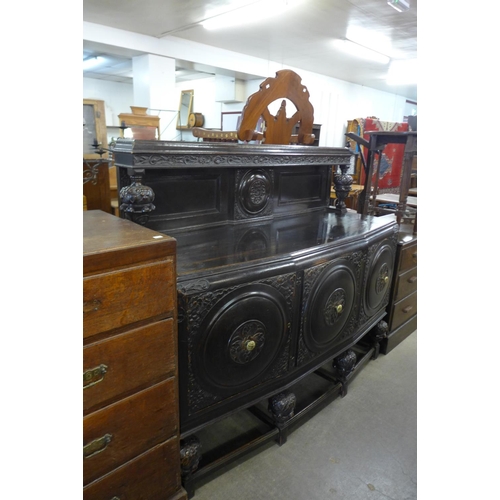 161 - A carved oak seven piece dining suite