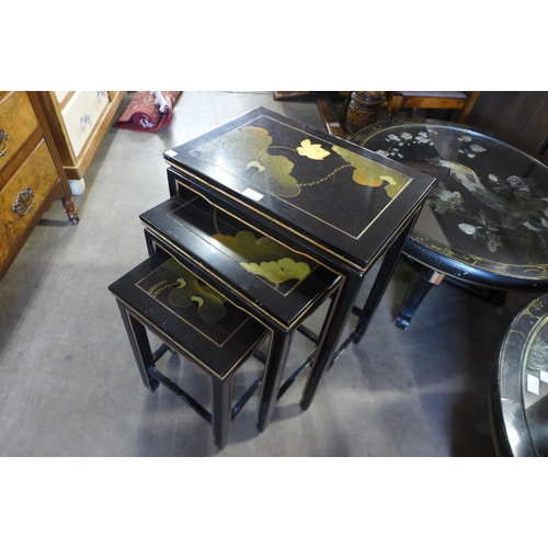 167 - A Chinese black lacquered chinoiserie nest of tables