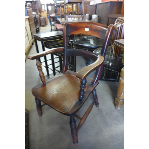 171 - A Victorian elm and beech kitchen elbow chair