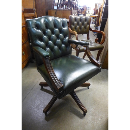 199 - A mahogany and green leather revolving desk chair