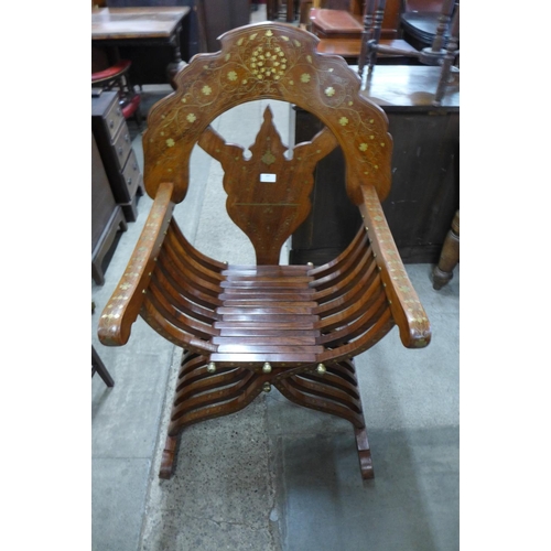 209 - A Syrian hardwood and brass inlaid x-frame armchair