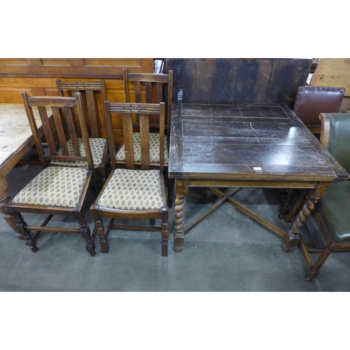 213 - An oak barleytwist draw-leaf table and four chairs