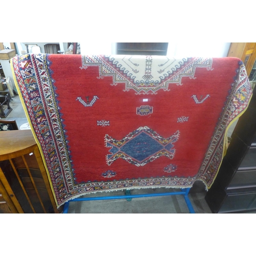 231 - A large eastern red ground rug