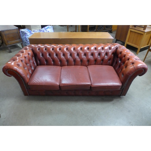 36 - A red leather Chesterfield settee