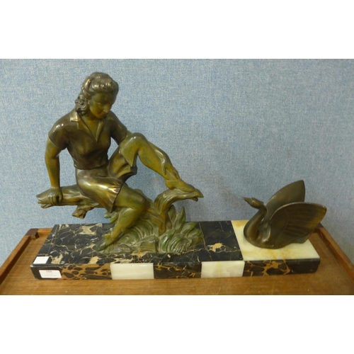 388 - An Art Deco spelter figure of a seated lady and a swan, on marble and alabaster plinth