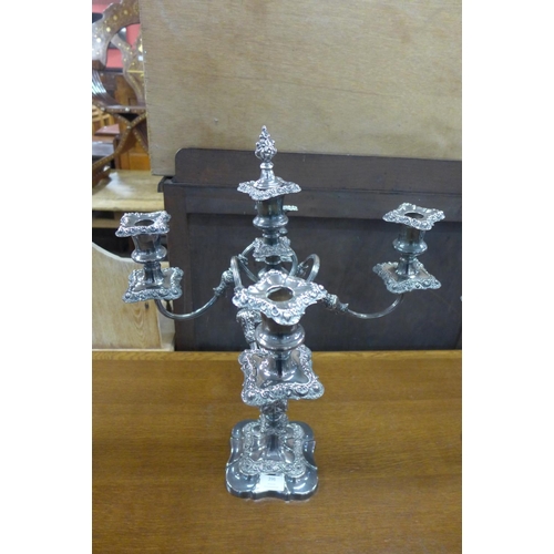 396 - A set of three plated candelabra