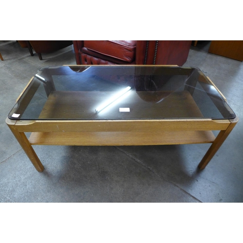 75 - A Myer teak and glass topped coffee table