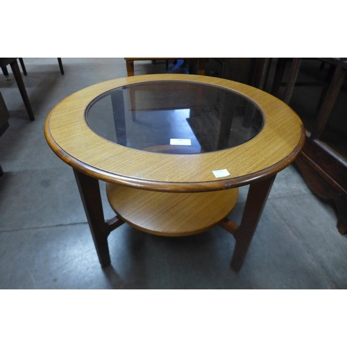 76 - A teak and glass topped circular coffee table