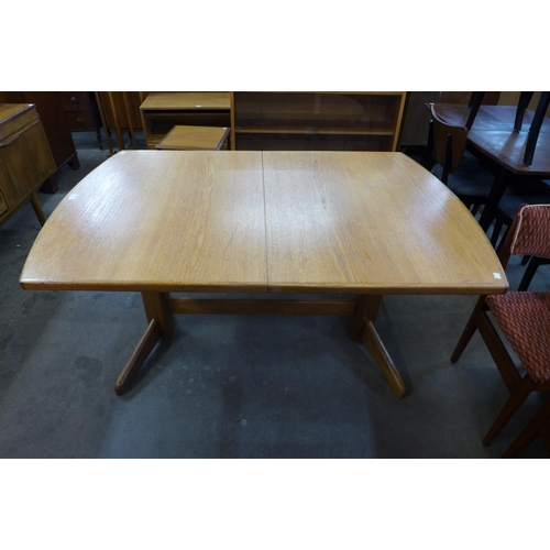 86 - A Danish teak extending dining table