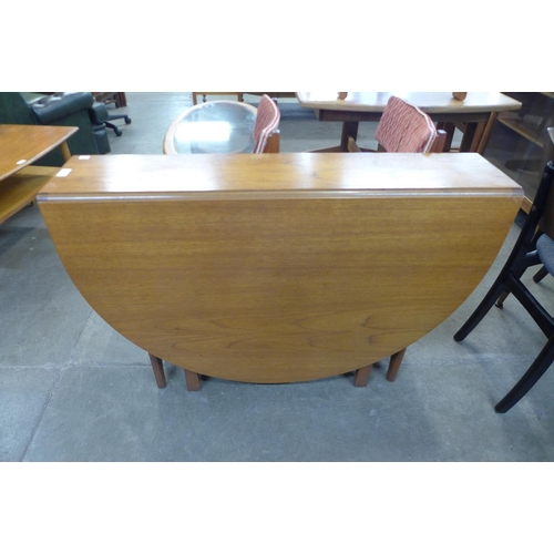 87 - A teak drop leaf table and four chairs