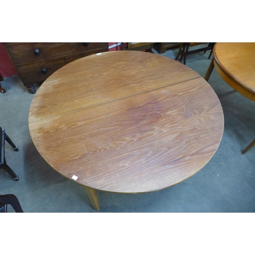 92 - A teak extending dining table