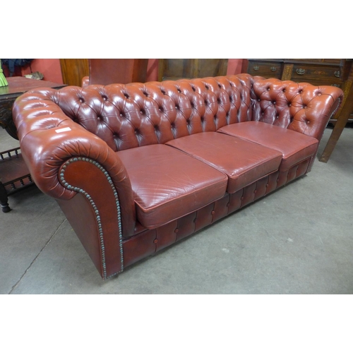 93 - A red leather Chesterfield settee