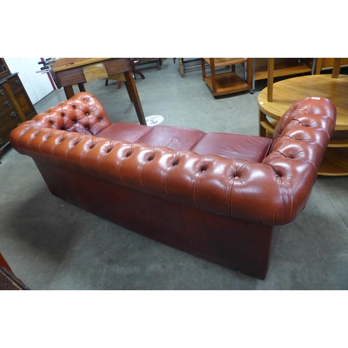 93 - A red leather Chesterfield settee