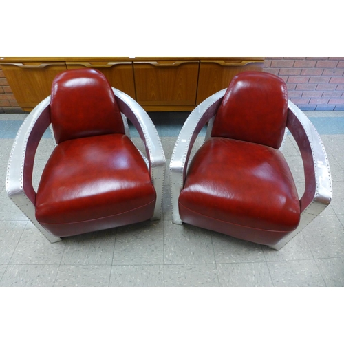 102 - A pair of riveted aluminium and red leather aviator chairs