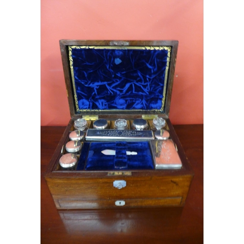 62 - A Victorian rosewood and mother of pearl inlaid lady's travelling vanity box