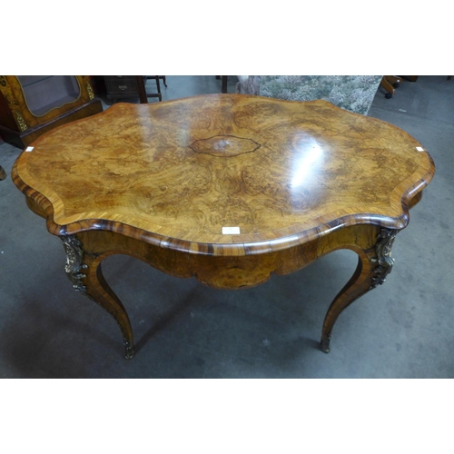 76 - A Victorian figured walnut and gilt metal serpentine centre table