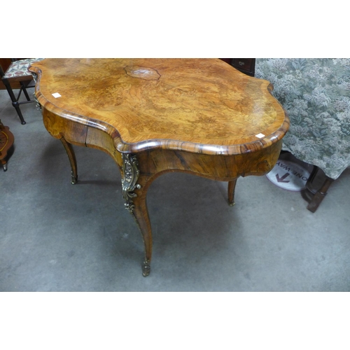 76 - A Victorian figured walnut and gilt metal serpentine centre table