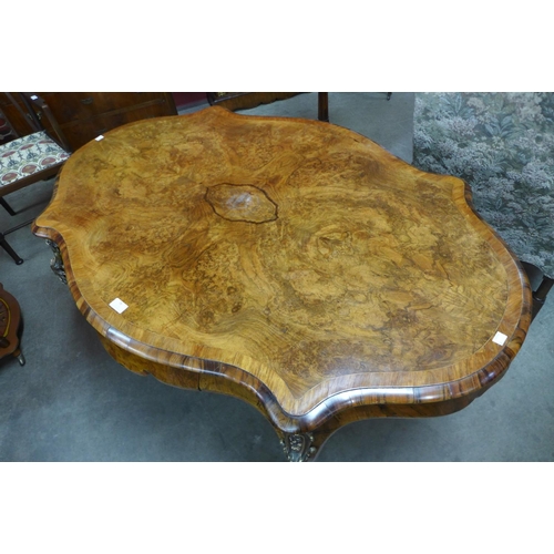 76 - A Victorian figured walnut and gilt metal serpentine centre table