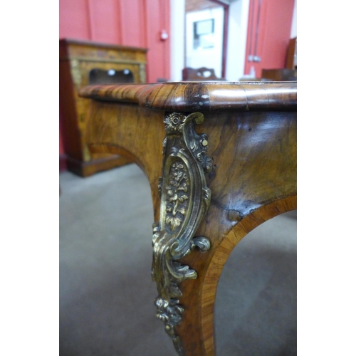 76 - A Victorian figured walnut and gilt metal serpentine centre table
