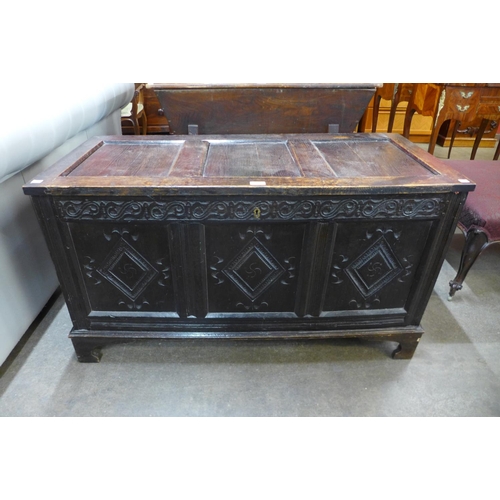 83 - A William III carved oak panelled coffer